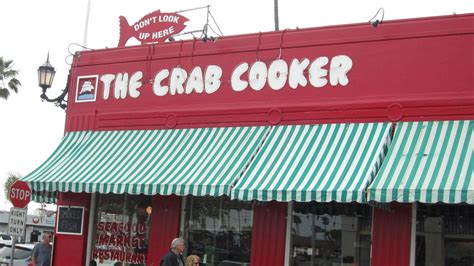 The crab cooker - The Crab Cooker restaurant is known for its casual atmosphere. The building's exterior is painted bright red. Inside, the restaurant decoration is a pastiche of unique items including paintings by famous artists, theater chandeliers , pots and pans, a wrought-iron gate, nautical equipment and a giant shark. 